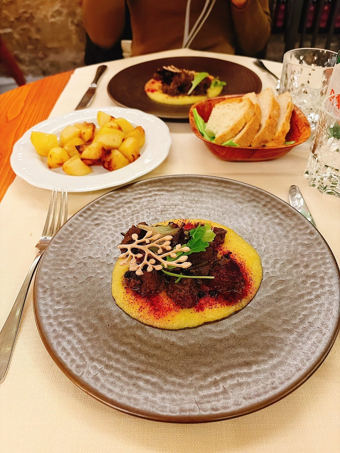 Braised meat on creamy polenta with elegant plating