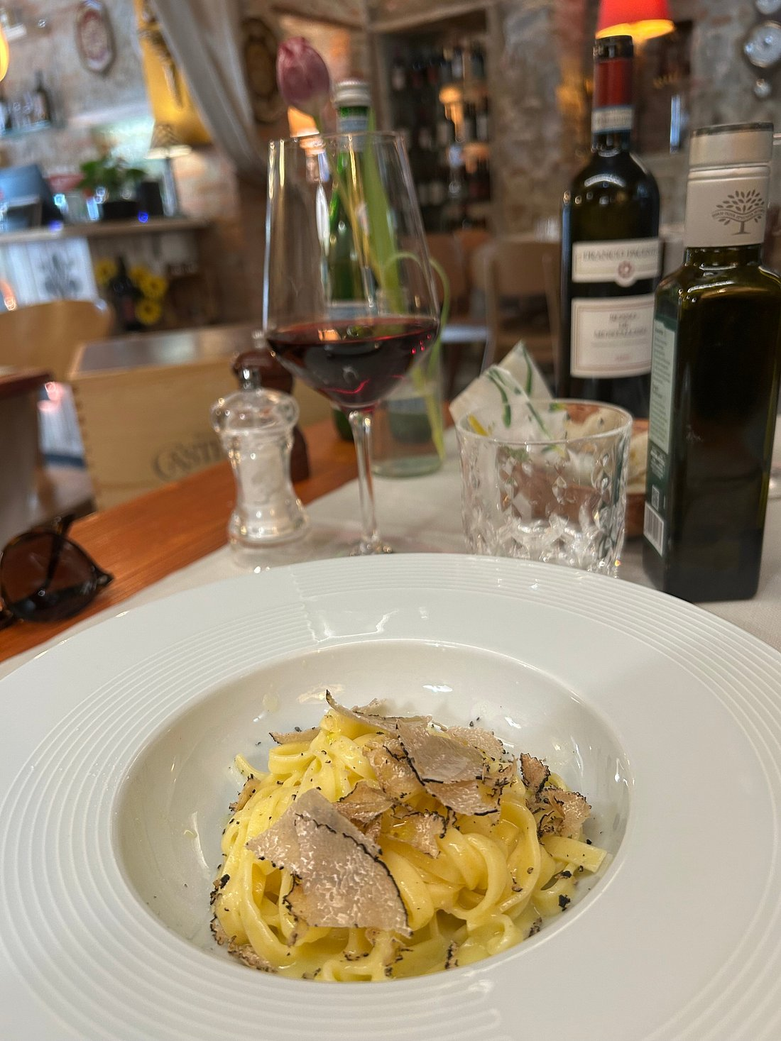 Fresh truffle tagliolini pasta with a glass of red wine
